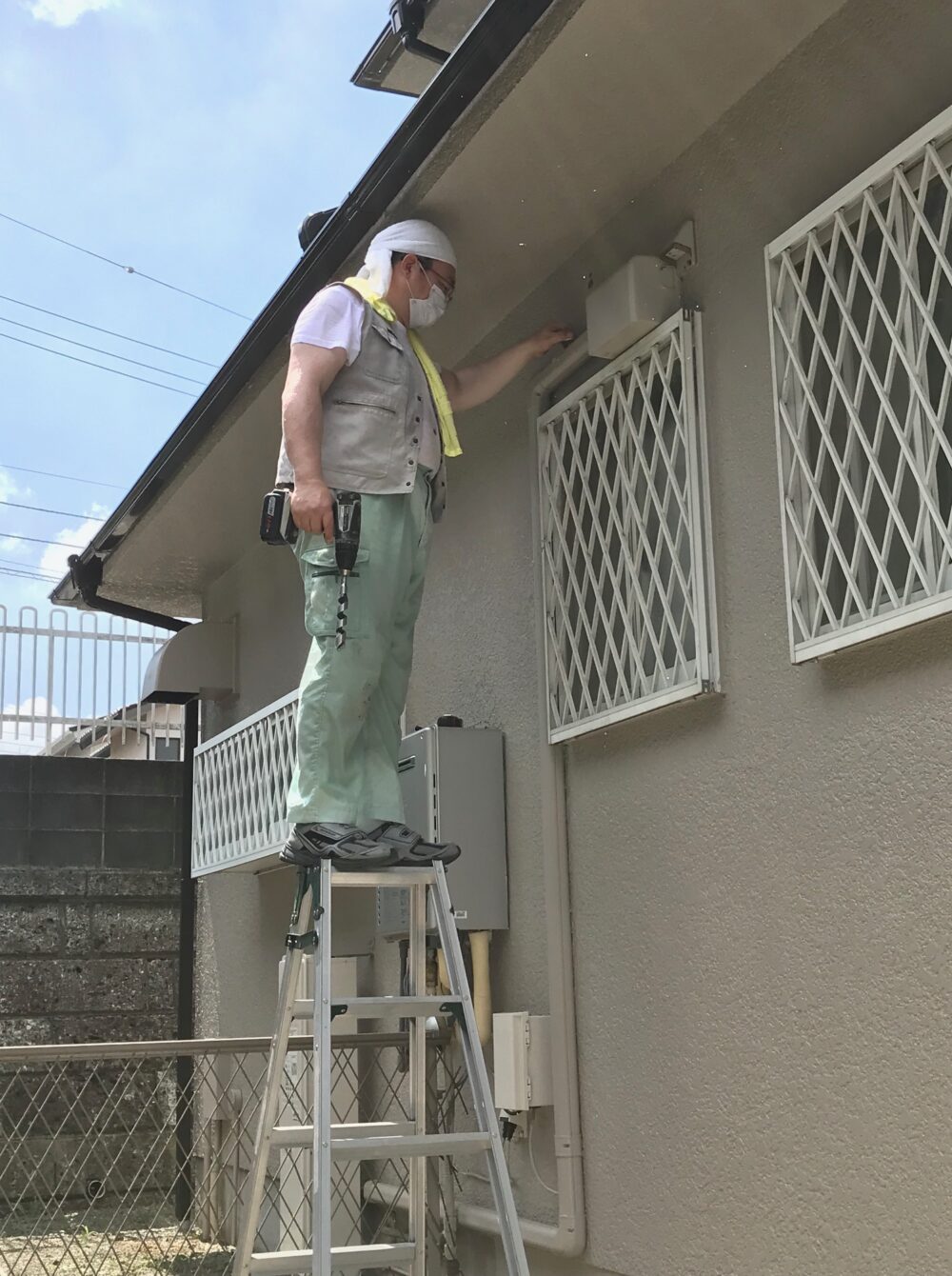 海老名市でのIH専用200V配線工事。屋外の露出配管を設置する専門の電気技師による施工風景。